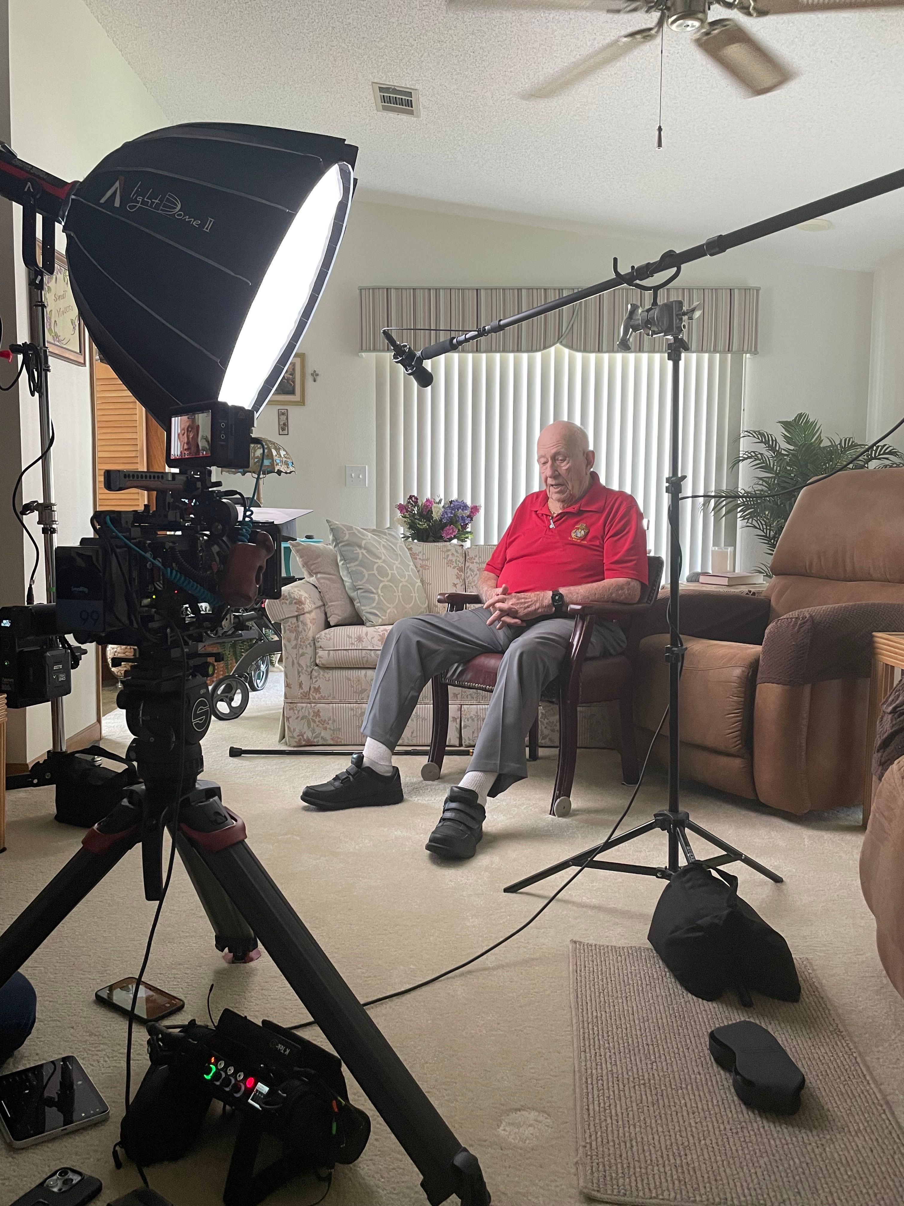 Elmer sits in front of the camera before the interview